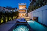 Outdoor, Back Yard, and Swimming Pools, Tubs, Shower The home's superyacht-inspired facade glows at dusk.  Photo 1 of 9 in A Yacht-Inspired Masterpiece on Santa Monica’s Gold Coast by Luxury Homes & Lifestyle