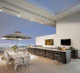 Sweeping outdoor space includes a kitchen and dining area for year-round entertaining.