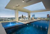 The home's resort-caliber swimming pool and spa overlook incredible city vistas.