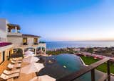 An incredible infinity edge pool and ample outdoor space overlook sweeping ocean vistas.
