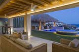 Interiors connect seamlessly to spacious outdoor living areas perched above the Pacific.