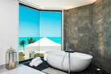 A large soaking tub overlooking sweeping coastal vistas.