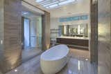 A sleek bathroom with a striking soaking tub is crowned by custom skylights above.