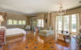 The magnificent master suite features a generous walk-in closet and elegant sitting area opening to a spectacular ocean-view terrace.