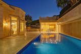 The pool and dining area assume an alluring glow at dark.