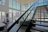 The glass-sided, architectural staircase complements the interiors.