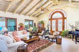 White-washed cathedral ceilings and arch-topped doors in the open-plan living room.