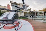 An integrated helipad for a personal drone helicopter graces the expansive pool terrace.