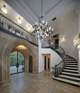 The soaring, two-story foyer is crowned by an antique chandelier sourced from a Paris flea market by Peggy Lee herself.   Photo 3 of 8 in Former Estate of Peggy Lee Sings in Bel Air by Luxury Homes & Lifestyle