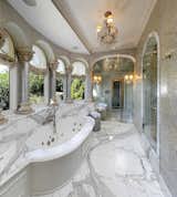 The opulent master bathroom with a marble soaking tub and series of walls and columns inlaid with ¼ million hand-cut pieces of mother of pearl from the Indian Ocean. 