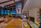 A large fireplace and built-in bookshelves lend the great room midcentury appeal.