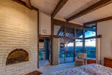 The exceptional master with a fireplace and private patio overlooking the pool and views.