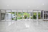 Soaring, open living spaces are lined with sliding glass walls for a seamless indoor-outdoor flow.