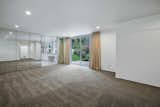 The expansive master suite connects to the patio and grounds beyond.