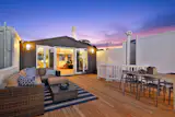 The rooftop terrace glows at twilight. 