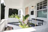 A charming sun porch overlooks the grassy front yard.