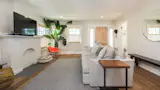 The spacious, open living  room features wide-plank oak floors.