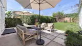 The large, grassy yard with dining patio is conceived for year-round entertaining.