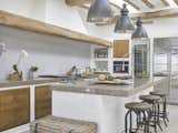 The chef's kitchen boasts high-end appliances and an eat-in island.