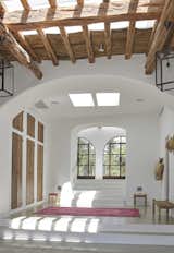 Rustic wood details and elegant archways elevate the living experience. 