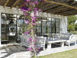 A rustic pergola is primed for dining and entertaining.