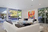 The open floor plan and sleek glass walls of windows creates a tranquil setting throughout the living spaces