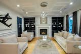 On the main floor, an ample formal living room with fireplace and coffered ceilings offer a sophisticated living space.  