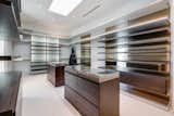 The walk-in closet resembles a luxury boutique.