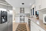 The remodeled, modern kitchen features Caesarstone countertops and stainless steel appliances. 