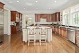 Fit for a Michelin-chef, the open-concept kitchen seems endless and has custom cabinetry, granite countertops, an oversized pantry, and every modern convenience one could dream of. 