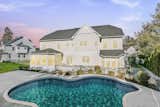 When not relaxing on the inviting cedar-roofed porch, the home’s resort-style backyard provides a true private oasis, featuring a Pebble Tec pool, a sprawling flagstone patio and a three-season Florida room. 