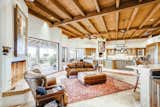 The interiors include a warm and inviting color palette replete with vaulted, wood beam ceilings and plaster block walls.