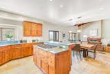 No detail is spared in the chef’s kitchen with its marble countertops, custom cabinetry, breakfast bar, dining area, and state-of-the-art Viking appliances.