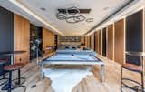 The lower level offers a handsome and alluring private speakeasy with dark leather accents and walnut-paneled walls.