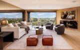 The main living area is expansive, with a formal living space complete with a fireplace that gives way to a spacious balcony.
