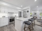 The chef’s kitchen features Skona custom cabinetry replete with an expansive pantry, pull-out magic corner, quartz countertops, under-mount cabinetry lighting, and brand new stainless steel appliances. 