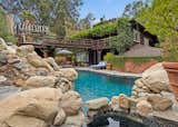 The outdoor entertaining space is expansive and inviting, with its own pool, lounge areas, a tennis court, and ample space for future expansion.