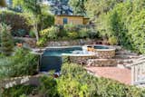 Terraced gardens, a pool, spa, koi ponds, and magical tea-house-styled wisteria-dressed arbors are featured in the outdoor entertaining space.