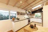 The gourmet kitchen is an ideal perch for hosting replete with custom concrete countertops and stainless steel appliances. 