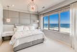 Boasting two bedrooms and two baths, each room showcases panoramic views of the ocean.
