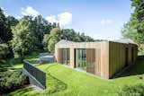 Valley Villa

Architectural firm Arches has recently created a contemporary, eco-friendly villa within close proximity to Vilnius, the capital of Lithuania and the country’s largest city. Clad in 7,000 sq. ft. of sustainable Kebony wood, this unique property has been built to complement the scenery, with natural timber cladding and irregular pitched roofs, characteristic of the neighbouring surroundings and in harmony with the hillsides and pine trees. The villa strikes the perfect balance with an architectural style that is simultaneously modern and traditional.

The clean, angular design creates a minimalist exterior with Kebony as the prime material contrasting against the black slate at the building’s base. Architect, Arūnas Liola, aimed to design a structure that is both ecologically friendly and striking in appearance, interweaving natural materials with a bold sculptural form.  The firm has frequently chosen to work with Kebony due to the fact that it is a natural material but with the resistance to stand up to testing conditions far better than softwood. The quality of the wood, and through the skills of an exceptional carpenter, meant the timber could be sculpted and worked with easily for this particular project. Kebony requires no additional treatment even when used as an external cladding, the material simply develops a silver-grey patina which will allow the house to adapt naturally to its surroundings over a period of time. 

The patented Kebony technology is an environmentally friendly process, which modifies sustainably sourced softwoods by heating the wood with furfuryl alcohol - an agricultural by-product. By polymerizing the wood’s cell wall, the softwoods permanently take on the attributes of tropical hardwood including high durability, hardness and dimensional stability, without the need for tropical deforestation, resulting in a high performing, beautiful wood product. 