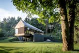 Valley Villa

Architectural firm Arches has recently created a contemporary, eco-friendly villa within close proximity to Vilnius, the capital of Lithuania and the country’s largest city. Clad in 7,000 sq. ft. of sustainable Kebony wood, this unique property has been built to complement the scenery, with natural timber cladding and irregular pitched roofs, characteristic of the neighbouring surroundings and in harmony with the hillsides and pine trees. The villa strikes the perfect balance with an architectural style that is simultaneously modern and traditional.

The clean, angular design creates a minimalist exterior with Kebony as the prime material contrasting against the black slate at the building’s base. Architect, Arūnas Liola, aimed to design a structure that is both ecologically friendly and striking in appearance, interweaving natural materials with a bold sculptural form.  The firm has frequently chosen to work with Kebony due to the fact that it is a natural material but with the resistance to stand up to testing conditions far better than softwood. The quality of the wood, and through the skills of an exceptional carpenter, meant the timber could be sculpted and worked with easily for this particular project. Kebony requires no additional treatment even when used as an external cladding, the material simply develops a silver-grey patina which will allow the house to adapt naturally to its surroundings over a period of time. 

The patented Kebony technology is an environmentally friendly process, which modifies sustainably sourced softwoods by heating the wood with furfuryl alcohol - an agricultural by-product. By polymerizing the wood’s cell wall, the softwoods permanently take on the attributes of tropical hardwood including high durability, hardness and dimensional stability, without the need for tropical deforestation, resulting in a high performing, beautiful wood product. 

