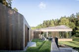 Valley Villa

Architectural firm Arches has recently created a contemporary, eco-friendly villa within close proximity to Vilnius, the capital of Lithuania and the country’s largest city. Clad in 7,000 sq. ft. of sustainable Kebony wood, this unique property has been built to complement the scenery, with natural timber cladding and irregular pitched roofs, characteristic of the neighbouring surroundings and in harmony with the hillsides and pine trees. The villa strikes the perfect balance with an architectural style that is simultaneously modern and traditional.

The clean, angular design creates a minimalist exterior with Kebony as the prime material contrasting against the black slate at the building’s base. Architect, Arūnas Liola, aimed to design a structure that is both ecologically friendly and striking in appearance, interweaving natural materials with a bold sculptural form.  The firm has frequently chosen to work with Kebony due to the fact that it is a natural material but with the resistance to stand up to testing conditions far better than softwood. The quality of the wood, and through the skills of an exceptional carpenter, meant the timber could be sculpted and worked with easily for this particular project. Kebony requires no additional treatment even when used as an external cladding, the material simply develops a silver-grey patina which will allow the house to adapt naturally to its surroundings over a period of time. 

The patented Kebony technology is an environmentally friendly process, which modifies sustainably sourced softwoods by heating the wood with furfuryl alcohol - an agricultural by-product. By polymerizing the wood’s cell wall, the softwoods permanently take on the attributes of tropical hardwood including high durability, hardness and dimensional stability, without the need for tropical deforestation, resulting in a high performing, beautiful wood product. 