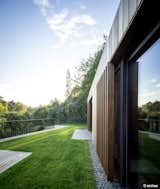 Valley Villa

Architectural firm Arches has recently created a contemporary, eco-friendly villa within close proximity to Vilnius, the capital of Lithuania and the country’s largest city. Clad in 7,000 sq. ft. of sustainable Kebony wood, this unique property has been built to complement the scenery, with natural timber cladding and irregular pitched roofs, characteristic of the neighbouring surroundings and in harmony with the hillsides and pine trees. The villa strikes the perfect balance with an architectural style that is simultaneously modern and traditional.

The clean, angular design creates a minimalist exterior with Kebony as the prime material contrasting against the black slate at the building’s base. Architect, Arūnas Liola, aimed to design a structure that is both ecologically friendly and striking in appearance, interweaving natural materials with a bold sculptural form.  The firm has frequently chosen to work with Kebony due to the fact that it is a natural material but with the resistance to stand up to testing conditions far better than softwood. The quality of the wood, and through the skills of an exceptional carpenter, meant the timber could be sculpted and worked with easily for this particular project. Kebony requires no additional treatment even when used as an external cladding, the material simply develops a silver-grey patina which will allow the house to adapt naturally to its surroundings over a period of time. 

The patented Kebony technology is an environmentally friendly process, which modifies sustainably sourced softwoods by heating the wood with furfuryl alcohol - an agricultural by-product. By polymerizing the wood’s cell wall, the softwoods permanently take on the attributes of tropical hardwood including high durability, hardness and dimensional stability, without the need for tropical deforestation, resulting in a high performing, beautiful wood product. 