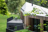 Valley Villa

Architectural firm Arches has recently created a contemporary, eco-friendly villa within close proximity to Vilnius, the capital of Lithuania and the country’s largest city. Clad in 7,000 sq. ft. of sustainable Kebony wood, this unique property has been built to complement the scenery, with natural timber cladding and irregular pitched roofs, characteristic of the neighbouring surroundings and in harmony with the hillsides and pine trees. The villa strikes the perfect balance with an architectural style that is simultaneously modern and traditional.

The clean, angular design creates a minimalist exterior with Kebony as the prime material contrasting against the black slate at the building’s base. Architect, Arūnas Liola, aimed to design a structure that is both ecologically friendly and striking in appearance, interweaving natural materials with a bold sculptural form.  The firm has frequently chosen to work with Kebony due to the fact that it is a natural material but with the resistance to stand up to testing conditions far better than softwood. The quality of the wood, and through the skills of an exceptional carpenter, meant the timber could be sculpted and worked with easily for this particular project. Kebony requires no additional treatment even when used as an external cladding, the material simply develops a silver-grey patina which will allow the house to adapt naturally to its surroundings over a period of time. 

The patented Kebony technology is an environmentally friendly process, which modifies sustainably sourced softwoods by heating the wood with furfuryl alcohol - an agricultural by-product. By polymerizing the wood’s cell wall, the softwoods permanently take on the attributes of tropical hardwood including high durability, hardness and dimensional stability, without the need for tropical deforestation, resulting in a high performing, beautiful wood product. 