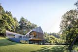 Valley Villa

Architectural firm Arches has recently created a contemporary, eco-friendly villa within close proximity to Vilnius, the capital of Lithuania and the country’s largest city. Clad in 7,000 sq. ft. of sustainable Kebony wood, this unique property has been built to complement the scenery, with natural timber cladding and irregular pitched roofs, characteristic of the neighbouring surroundings and in harmony with the hillsides and pine trees. The villa strikes the perfect balance with an architectural style that is simultaneously modern and traditional.

The clean, angular design creates a minimalist exterior with Kebony as the prime material contrasting against the black slate at the building’s base. Architect, Arūnas Liola, aimed to design a structure that is both ecologically friendly and striking in appearance, interweaving natural materials with a bold sculptural form.  The firm has frequently chosen to work with Kebony due to the fact that it is a natural material but with the resistance to stand up to testing conditions far better than softwood. The quality of the wood, and through the skills of an exceptional carpenter, meant the timber could be sculpted and worked with easily for this particular project. Kebony requires no additional treatment even when used as an external cladding, the material simply develops a silver-grey patina which will allow the house to adapt naturally to its surroundings over a period of time. 

The patented Kebony technology is an environmentally friendly process, which modifies sustainably sourced softwoods by heating the wood with furfuryl alcohol - an agricultural by-product. By polymerizing the wood’s cell wall, the softwoods permanently take on the attributes of tropical hardwood including high durability, hardness and dimensional stability, without the need for tropical deforestation, resulting in a high performing, beautiful wood product. 