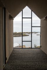 The artist’s retreat, founded by Norwegian composer and musician Håvard Lund, provides a tranquil haven to focus on creative pursuits. Completed in August 2016, the retreat, aptly named Fordypningsrommet or ‘room for deeper studies’ started out with just six mono-functional Kebony clad houses. Growing demand has since led to the completion of three more buildings and now the retreat can accommodate up to 12 guests.
Situated north of the Arctic Circle on the stunning island of archipelago Fleinvær, which encompasses between 200 and 300 islands, the artists’ retreat blends seamlessly into the surrounding rocky landscape. Each house is built on top of angled steel feet which creates a dramatic effect through the use of sharp lines and angles. The stylized architecture provides each house, consisting of a sauna, kitchen house, studio, bath house, sleeping houses and the so called Njalla or ‘tower for big thoughts’, with a degree of individuality. The exposed position of the retreat on the picturesque coastline provides a dramatic and ever-changing backdrop, with crisp coastal breezes bringing in the morning to the tranquil majesty of the Northern Lights illuminating the night sky.
This stunning setting is sure to inspire tranquillity and lend intensity to both recreational and artistic pursuits of its vacationers. On a self-catering basis, groups of up to 12 people are welcome to visit for a week for the price of $4,500 while artists wishing to stay for free at the retreat must be approved by a committee of three comprising; Musician, Nora Taksdal, Director, Katrine Strøm and General Manager, Håvard Lund. Those who are successful are required to pay for their travel to Bodø, however, beyond that everything in their stay is free of charge. At the end of their stay artists are invited to display their work at a public meeting which takes the form of a pre-show or lecture to the other artists staying on the remote island. This aspect of sharing knowledge is an integral part of the ethos at the retreat, and the architectural workshops conducted there have inspired students from all over the world, enabling them to acquire additional skills from preparing food to learning to fish.
The retreat is intended to be a return to nature as well as an artistic endeavour, and as such there has been a strong emphasis on sustainability throughout. Kebony, the sustainable alternative to tropical hardwood was carefully selected as the cladding material for each house. The Kebony technology uses an environmentally friendly process, which enhances the properties of sustainable softwood with a bio-based liquid derived from agricultural crop waste. By polymerizing the wood’s cell wall with furfuryl alcohol, the wood gains greatly improved durability and dimensional stability, similar to the characteristics of tropical hardwood. Shortly after installation started, the Kebony wood has begun to develop a delicate silver patina, as it weathers naturally. The dappled silvery tones of the wood give the buildings a truly natural aesthetic as they perfectly complement the surrounding and unspoilt scenery.