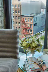 This vignette overlooking the High Line contains a vintage Fontana Arte side table and vintage slipper chair reminiscent of Prouve. Jarret sources items himself in Miami and Palm Beach so that he can provide his clients top-flight pieces without the expensive markup of mid-century furniture specialist stores. He then has them refinished and reupholstered by the local experts in South Florida, old-hands at restoring mid-century masterpieces.