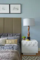 Grey does not mean boring. We updated a mid-century white lacquered brutalist nightstand by Milo Baughman to complement the 60s Laurel lamp and custom lampshade. Charcoal drawings by Scarlett Bailey, based in New York City and Mexico City, add a finishing touch of calm and luxury. 