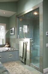 Master Bathroom is bathed in tones of blue-green with steam shower of recycled glass.